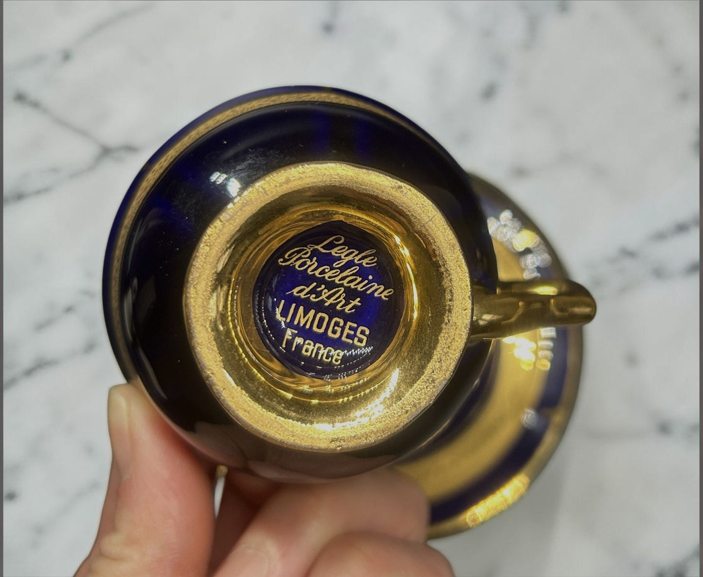 C&C Atelier Gilded Porcelain Teacup and Saucer, cobalt blue with gold interior and detailing, French Limoges porcelain.