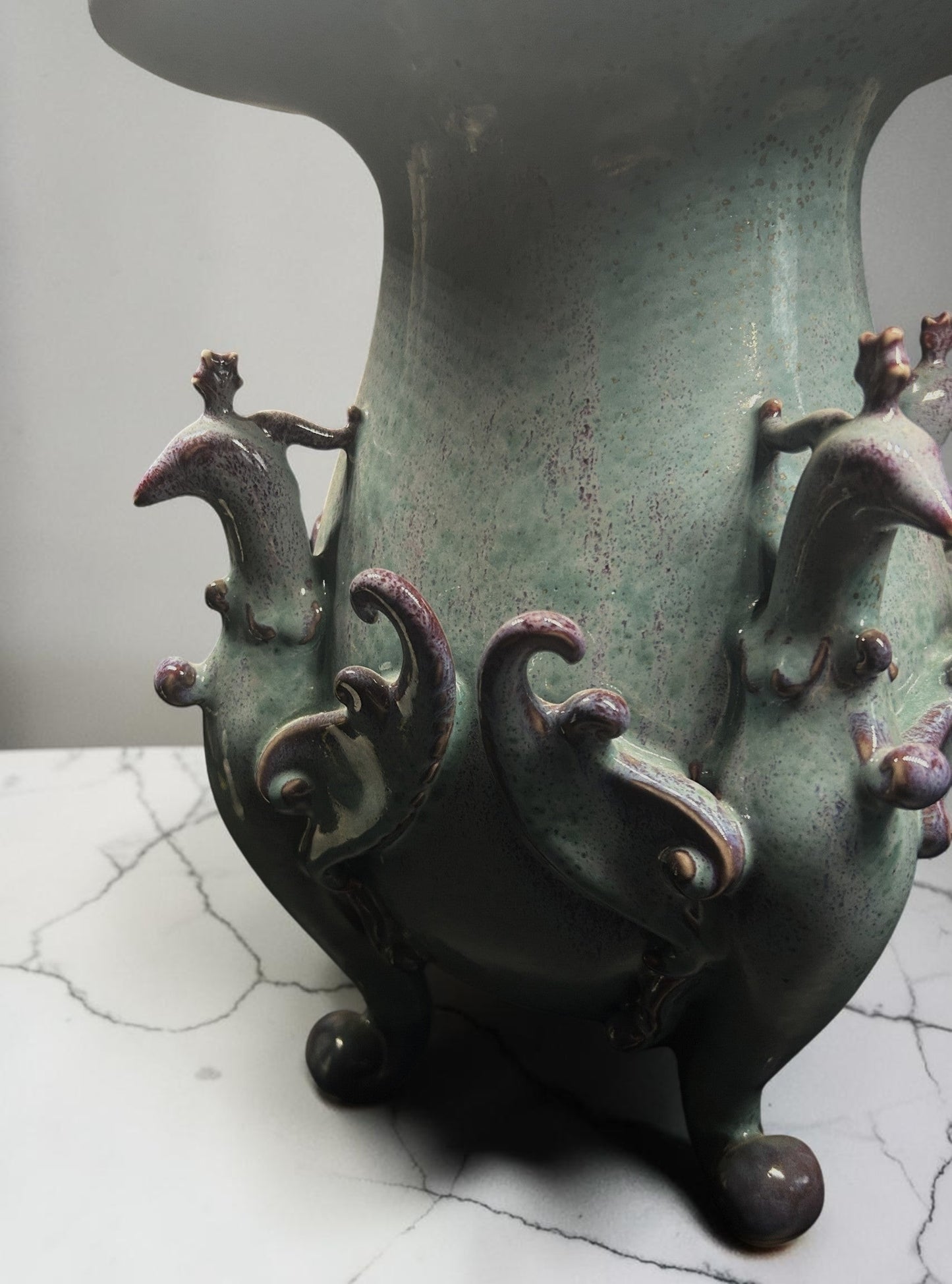 C&C Atelier celadon ceramic vase with purple accents and sculpted bird motifs on a tripod base.