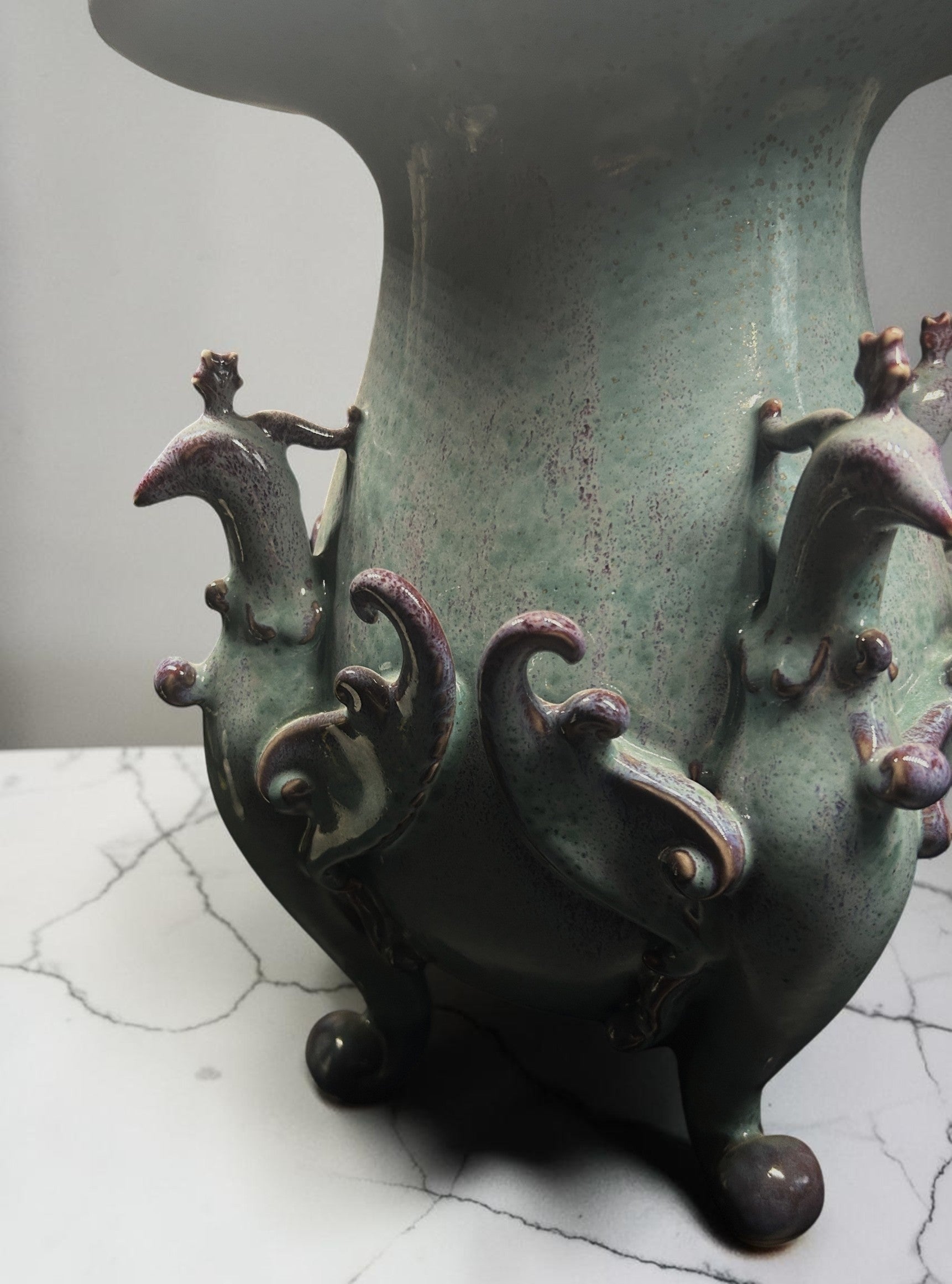 C&C Atelier celadon ceramic vase with purple accents and sculpted bird motifs on a tripod base.