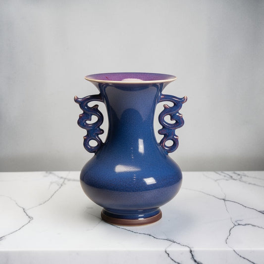 C&C Atelier deep blue speckled ceramic vase with ornate dragon handles and flared rim.