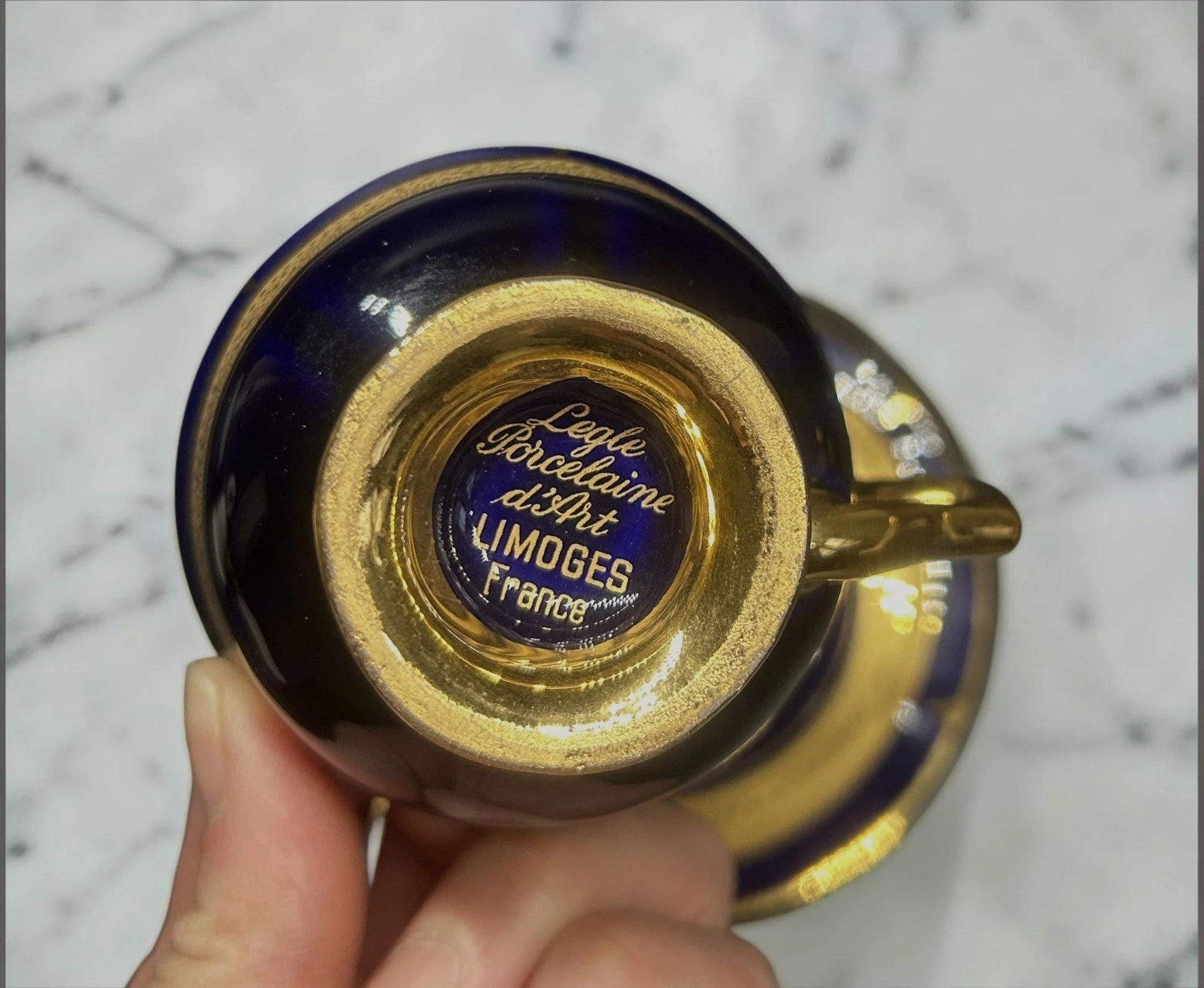 C&C Atelier Gilded Porcelain Teacup and Saucer, cobalt blue with gold interior and detailing, French Limoges porcelain.