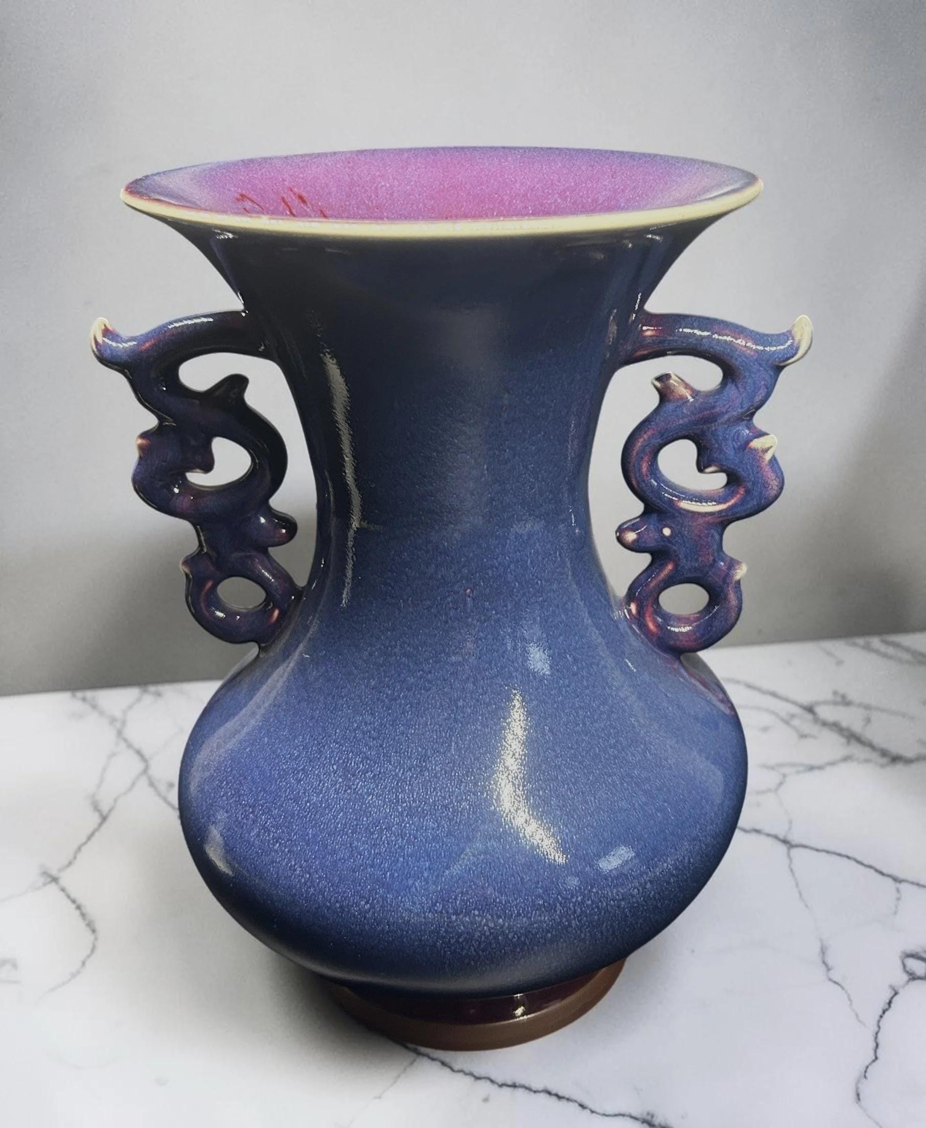 C&C Atelier decorative blue ceramic vase with flared rim and dragon-inspired handles, purple interior.